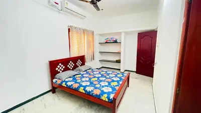 a small bedroom with a bed in a room at White House - 2BHK - Esha Apartment in Coimbatore