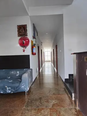 a living room with a bed and a hallway at Hotel New Cresent park in Coimbatore