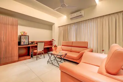 a living room with a couch and a table at Hotel Hari Govindas Mysore - Explore the Heart of Mysore in Mysore