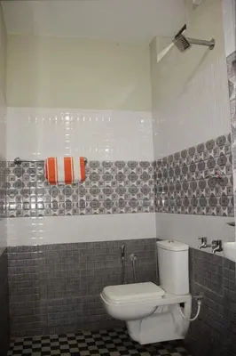 a bathroom with a toilet and a sink at Blue Lake in Kanthalloor