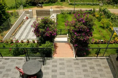an overhead view of a garden with benches and flowers at Blue Lake in Kanthalloor