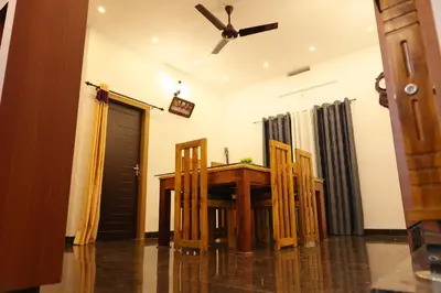 a dining room with a wooden table and chairs at Le Serene in Meenangadi