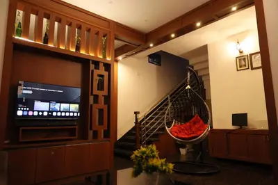 a living room with a staircase and a television at Le Serene in Meenangadi