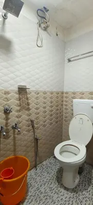 a bathroom with a toilet and a bath tub at geo gardens residency in Alwaye