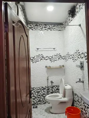 a bathroom with a toilet and a sink at geo gardens residency in Alwaye