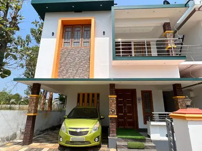 a small car parked in front of a house at Happy Villa Homestay - 2 in Chelakara