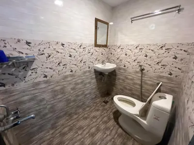 a bathroom with a toilet and a sink at Happy Villa Homestay - 2 in Chelakara