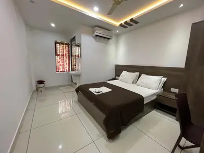 a bedroom with a bed in a room at RK Residency Calicut in Kozhikode