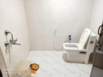 a white bathroom with a toilet and a sink at Streaming Valley Independent Coffee Estate Stay in Madikeri