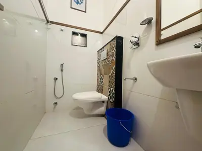 a bathroom with a toilet and a sink at Rio Rooms Calicut Near Mims Hospital in Kozhikode