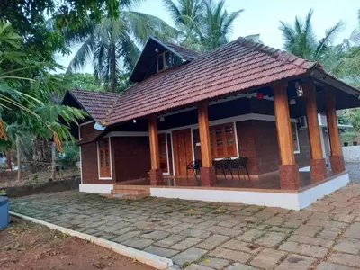a small house with a brown roof at Happy Land in Shoranūr