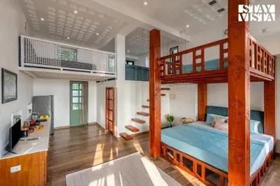 a bedroom with a bunk bed and a desk with a television at StayVista at Own The Beach Life - 1 BHK Pet Friendly - Beach View in Trichūr
