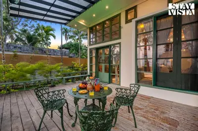 a patio with a table with fruit on it at StayVista at Own The Beach Life - 1 BHK Pet Friendly - Beach View in Trichūr