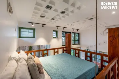 a bedroom with a bed on a balcony at StayVista at Own The Beach Life - 1 BHK Pet Friendly - Beach View in Trichūr