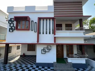 a storey house with a black and white checkered floor at Happy Villa Homestay - 4 in Chelakara