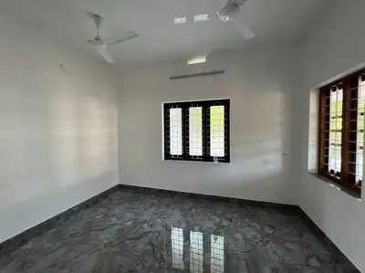 a white room with a painting on the wall at Happy Villa Homestay - 4 in Chelakara