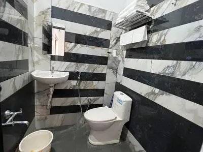 a bathroom with a white toilet and a sink at Happy Villa Homestay - 4 in Chelakara