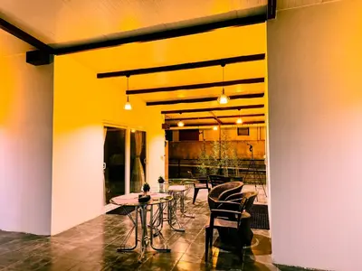 a room with a table and chairs and a yellow wall at Ooty Boulevard in Ooty