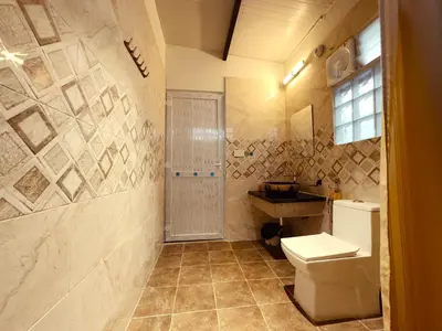 a bathroom with a toilet and a sink at Ooty Boulevard in Ooty