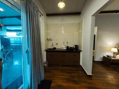 a bathroom with a tub and a sink in a room at Ooty Boulevard in Ooty