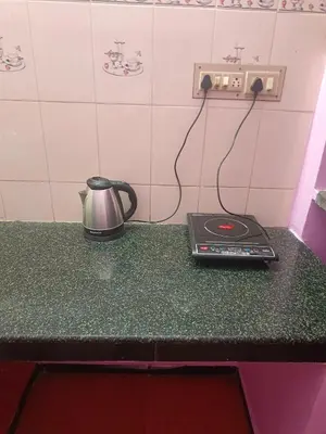 a tea kettle on a counter in a kitchen at Shivalaya Stays - Coimbatore in Coimbatore