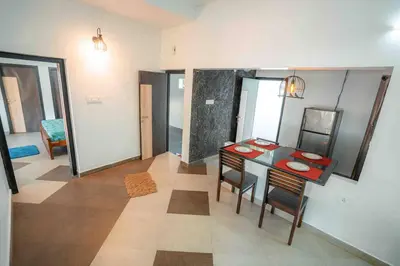a room with a table and chairs in a room at Cabana by Grha - Charming Cottage at Kappad Beach in Kozhikode