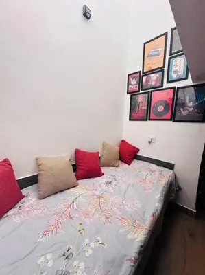 a bedroom with a bed with red pillows on it at Aanandam - An Independent Villa in 1 Acre Farm in Wayanad