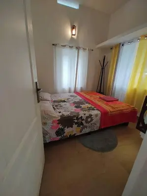 a small bedroom with a bed in a room at Aanandam - An Independent Villa in 1 Acre Farm in Wayanad