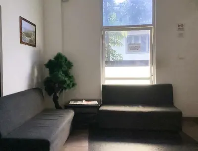 a living room with a couch and a window at Raaha Residency in Kozhikode