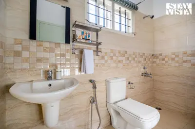 a bathroom with a sink and a toilet at StayVista at Orion's Crest ooty including breakfast in Ooty