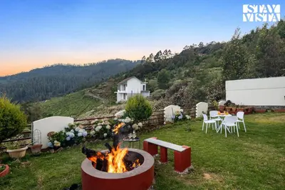 a fire pit in a yard with a table and chairs at StayVista at Orion's Crest ooty including breakfast in Ooty