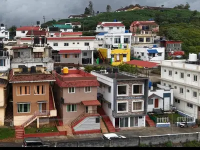 a group of houses on top of a hill at OOTY STAY AWHILE in Ooty