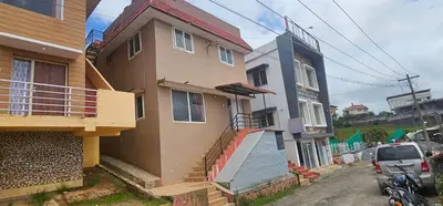a house with a car parked in front of it at OOTY STAY AWHILE in Ooty