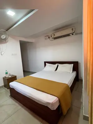 a bedroom with a large bed in a room at Plaza Residency in Badagara