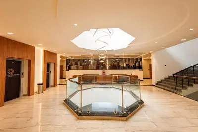 a glass display case in a lobby with stairs at THE CONTINENTAL INN & SUITES in Mysore