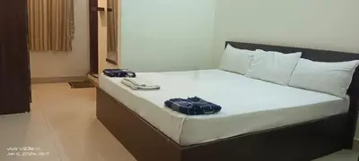 a bed with two bags sitting on top of it at ARIVU LODGE AC in Anaimalai