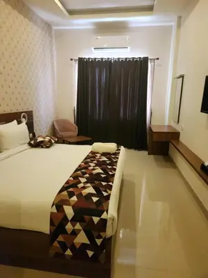 a bedroom with a bed with a black curtain at Le Sanara Residency in Thanniyam