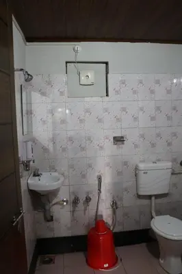a bathroom with a toilet and a sink at Verdant Hillock in Wayanad