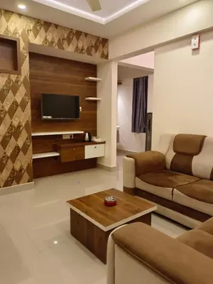 a living room with a couch and a tv at VVP Service Apartments in Nedumbassery