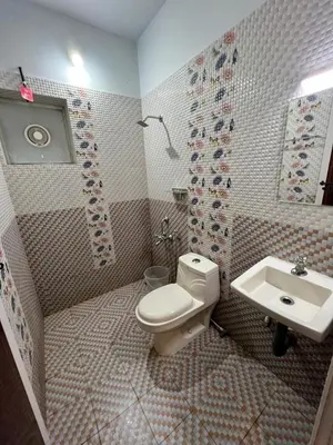 a bathroom with a toilet and a sink at Confident Residency in Guruvāyūr