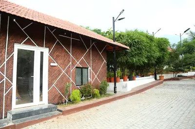 a red brick building with an open door on a street at GREEN MOUNT RESORTS in Malaiyāndipattanam