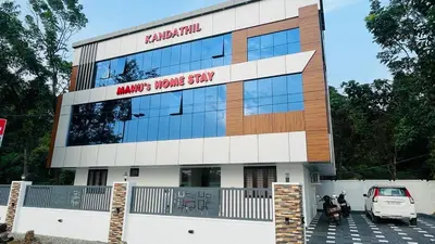 a building with a car parked in front of it at Manu's Home Stay in Malayāttūr