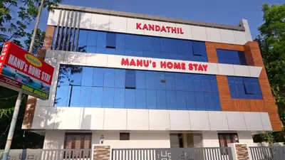 a building with a sign that reads manu home stay at Manu's Home Stay in Malayāttūr