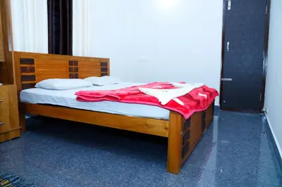 a bedroom with a wooden bed with a red blanket at Coorg Lotus Villa in Madikeri