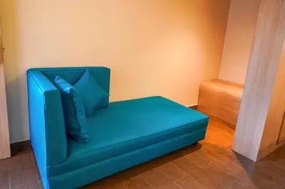 a blue chair sitting in the corner of a room at Trident in Ooty