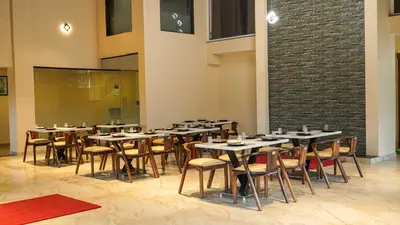 a group of tables and chairs in a room at Trident in Ooty