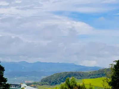 a view of a valley with mountains in the background at Vista Sunrise Resort Ooty Dodabetta in Ooty