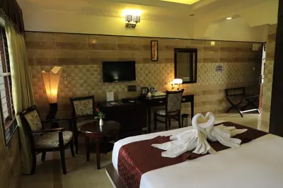 a hotel room with a bed with towels on it at Jal Mahal Resort and Spa in Mysore