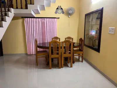 a dining room with a table and chairs at Manasam Homes Near To IIM & NIT - kOZHIKODE in Kunnamangalam