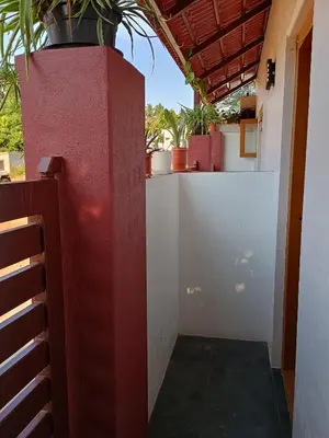 a red and white wall with a plant on it at Vigneshwara Nilaya in Mysore